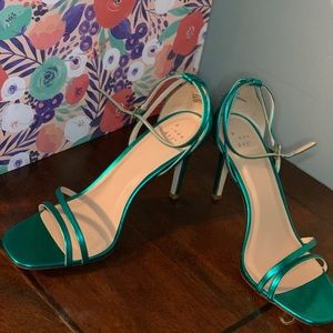 Metallic green sandals.